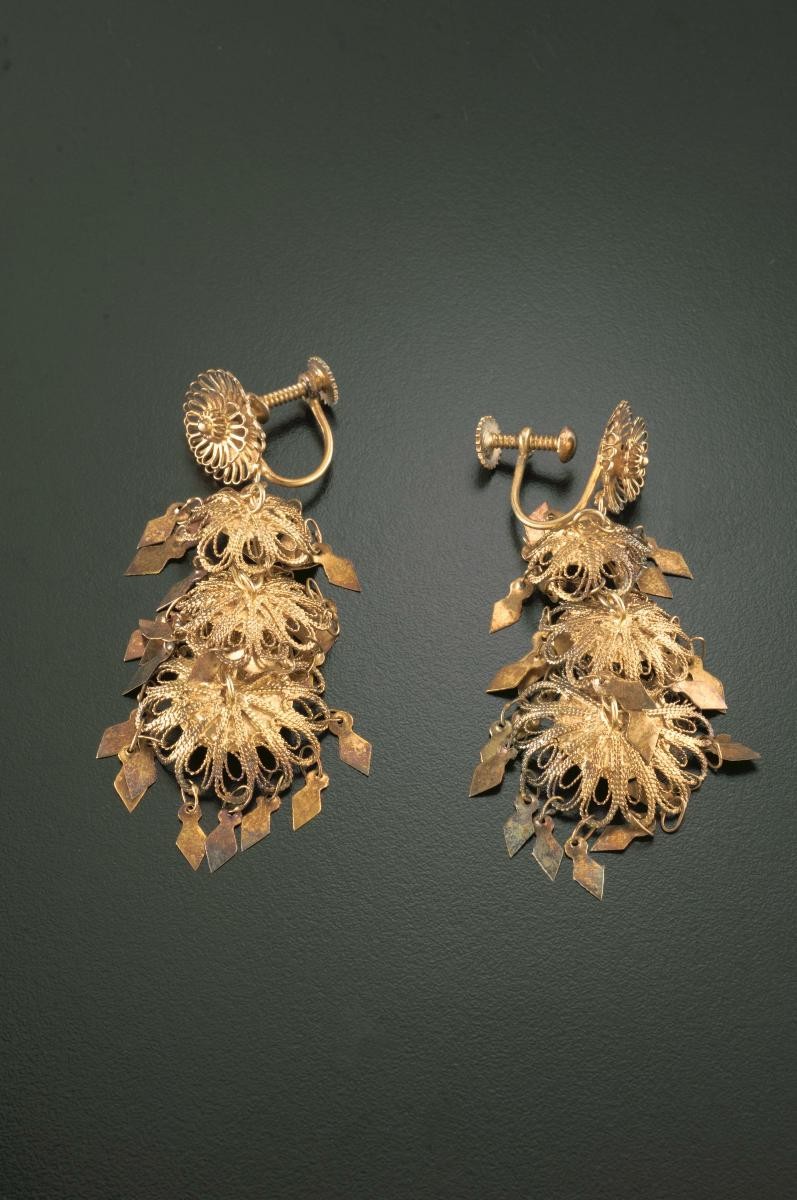 A pair of "golden leaf" ear rings that belonged to a notable women's rights activist