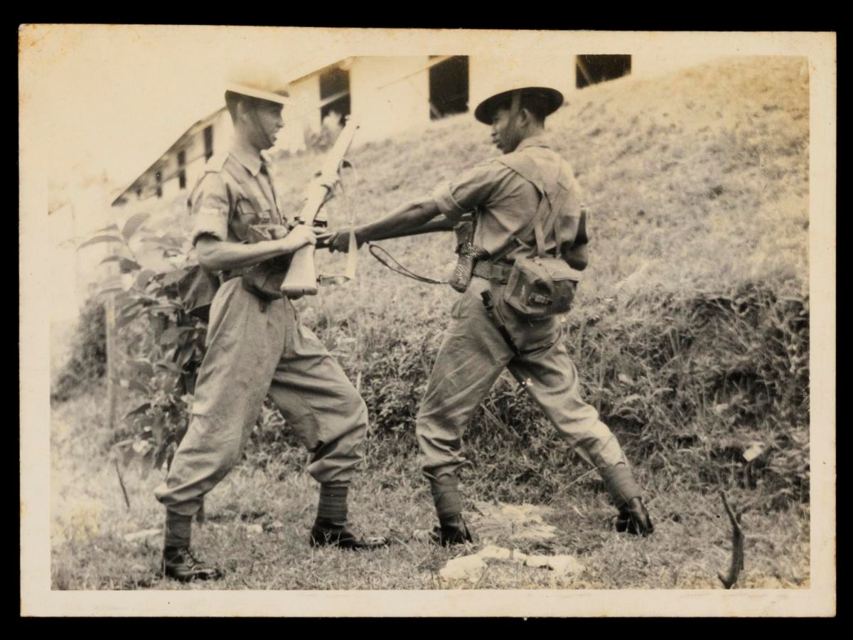 Photograph of two soldiers from the 1st Battalion, Singapore Infantry Regiment carrying out bayonet fighting practice