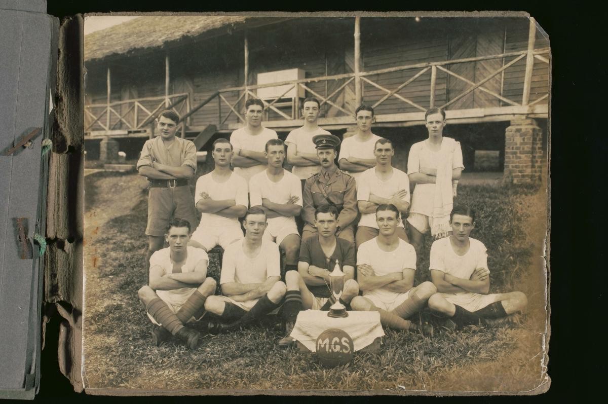 A military football team posing with their trophy at Tanglin Barracks