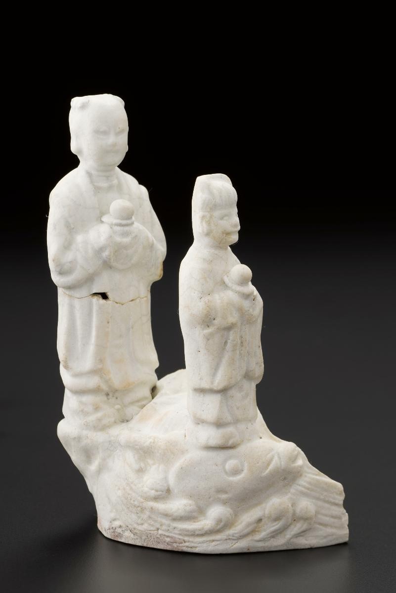 Figures of two devotees standing on waves
