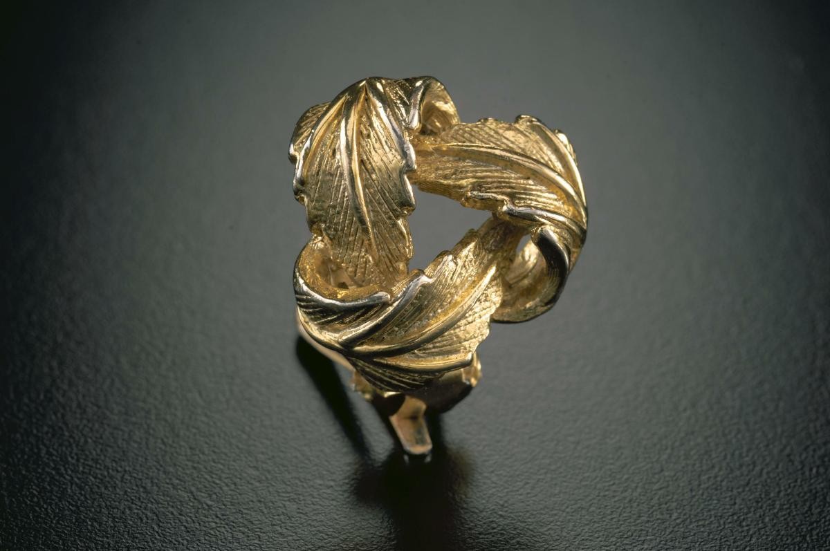A pair of golden "leaf knot" ear studs that belonged to a notable women's rights activist