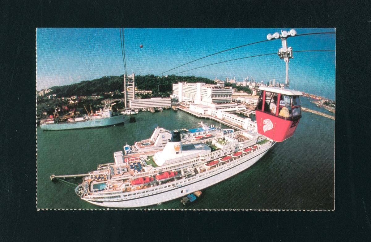Sentosa cable cars passing above a cruise liner