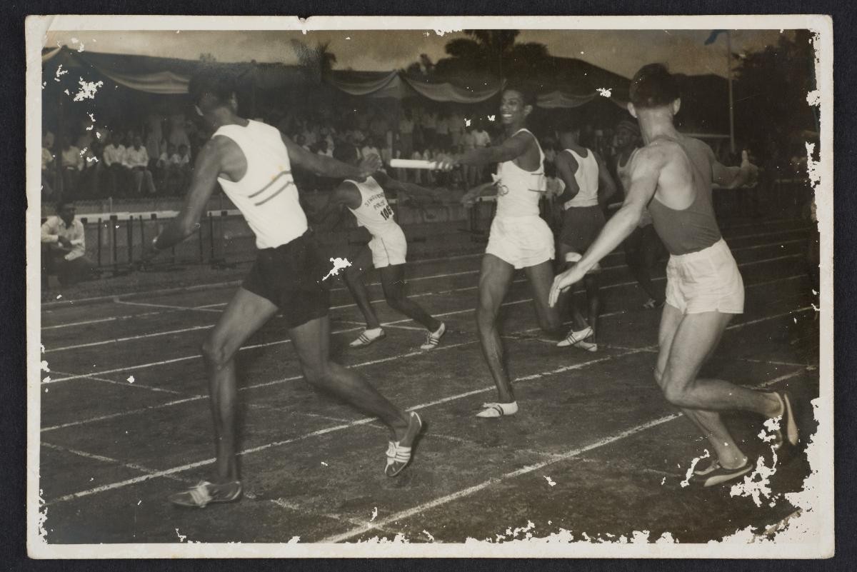 Jayaram S/o Rengasamy passing the baton to P.Ganesan, the winning 4x440 yards athletes at the Singapore Amateur Athletic Association, Farrer Park