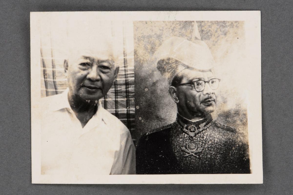 Photograph of Low Kway Song with portrait of Tunku Abdul Rahman