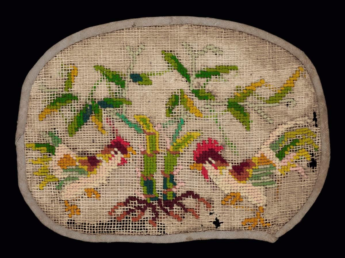 Needlework sampler with motifs of two roosters and young bamboo plants