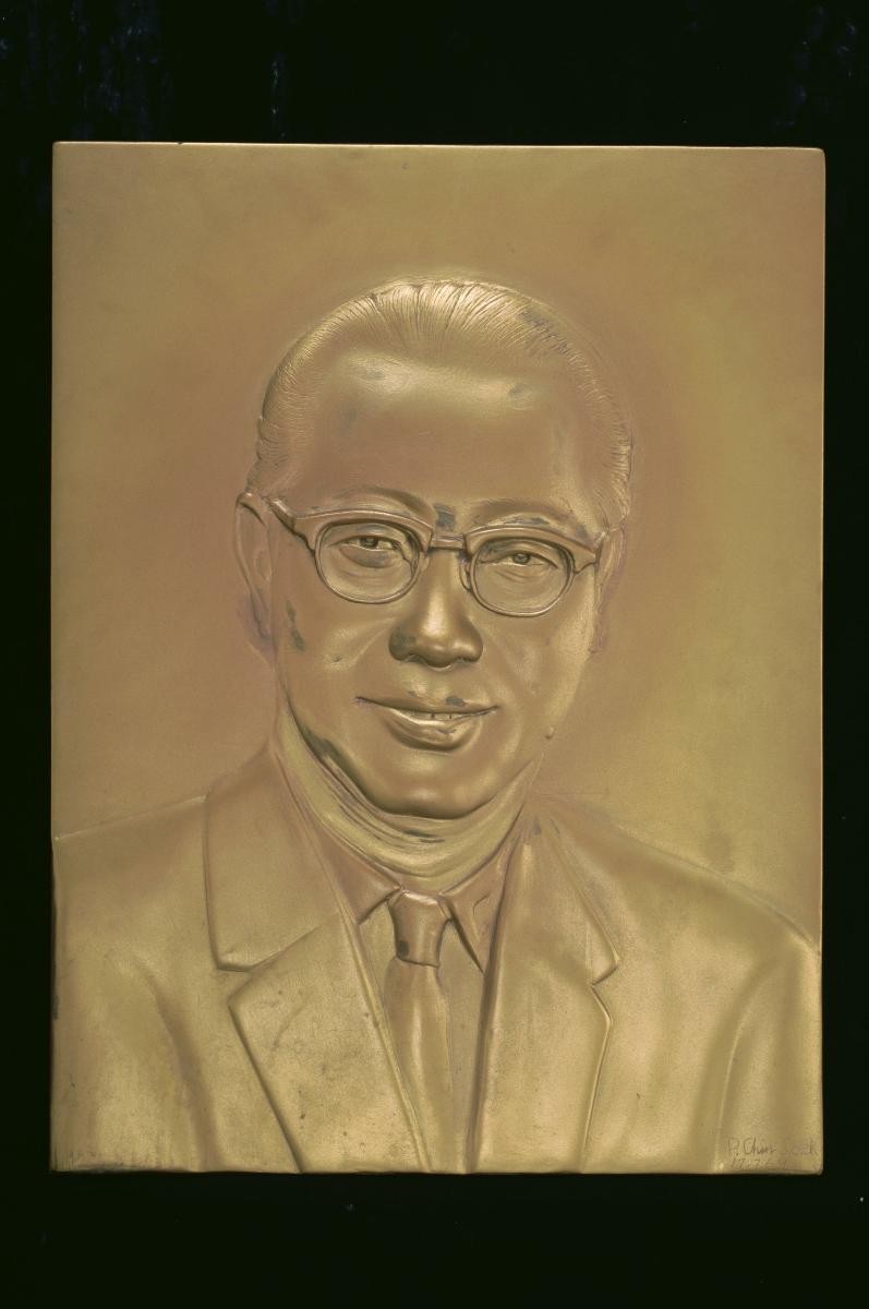 Wood relief portrait of Mr Lim Kim San in his younger days