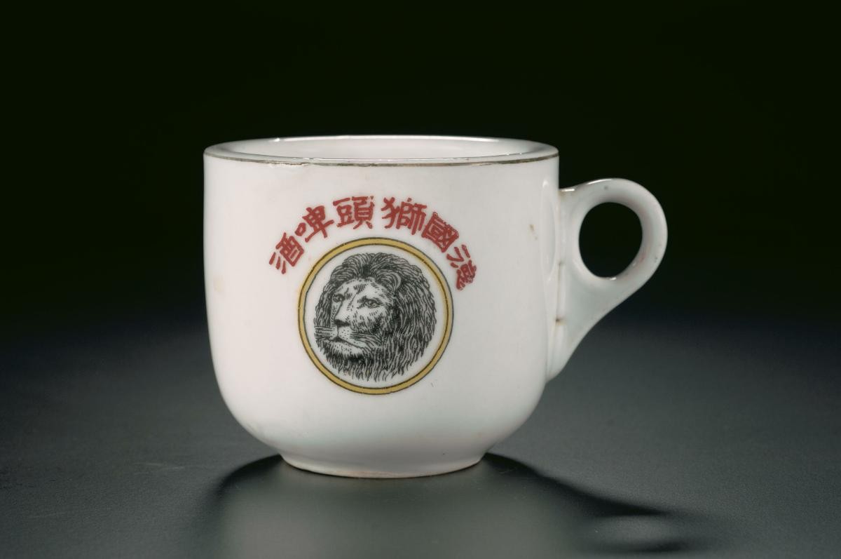 Kopitiam cup and saucer with the German Lion head beer logo
