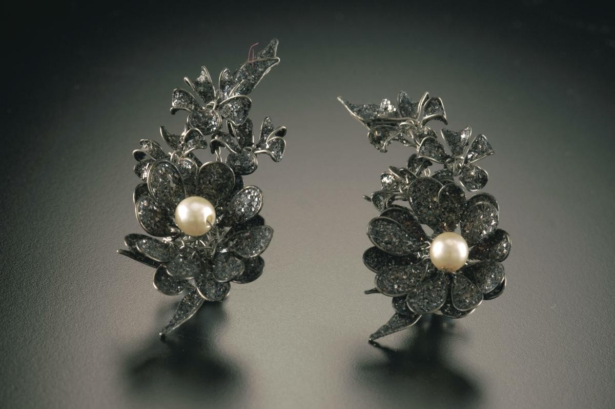 A pair of ear rings adorned with pearl and crystal that belonged to a notable women's rights activist