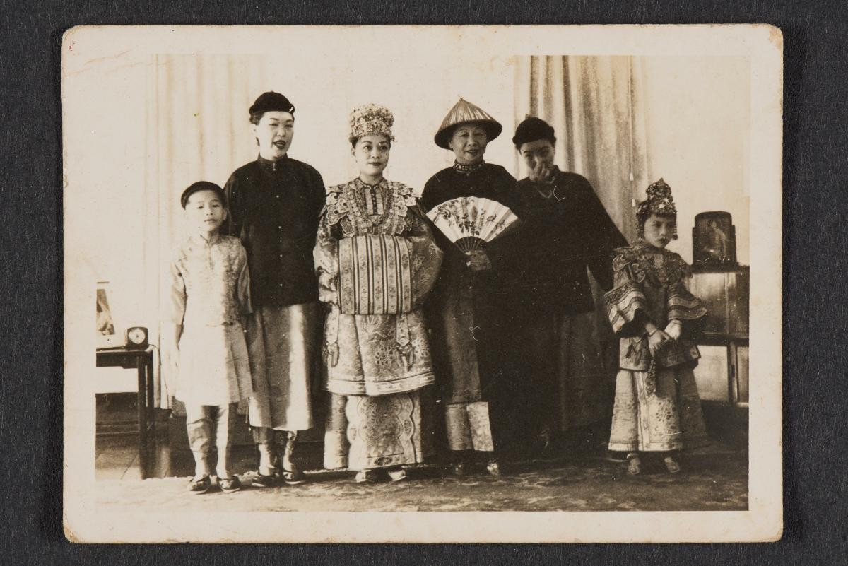 Photograph of a Peranakan bride and groom, and guests