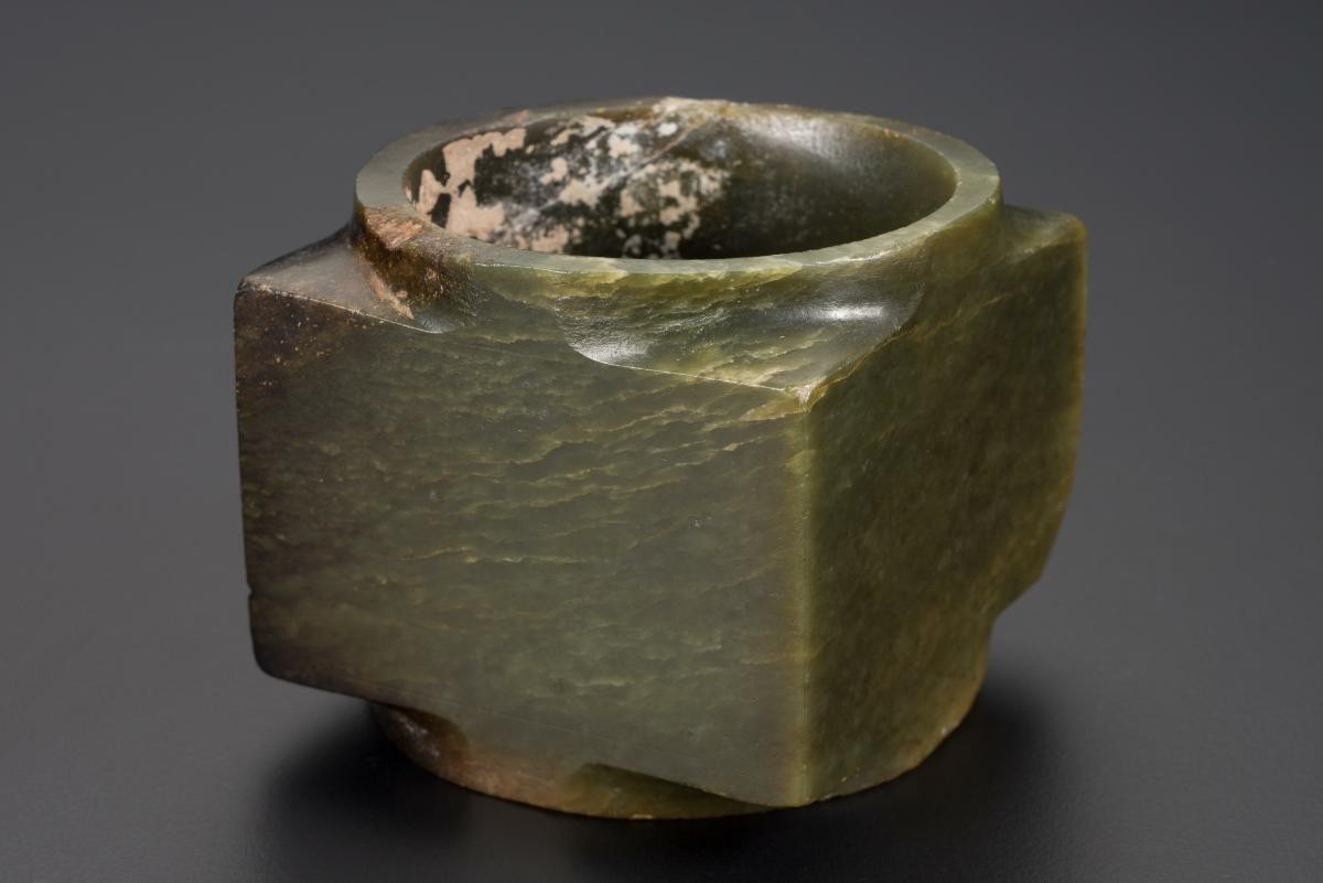 A dark olive-green and brown jade cong