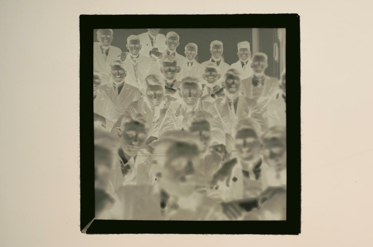 A glass plate negative depicting a group of men