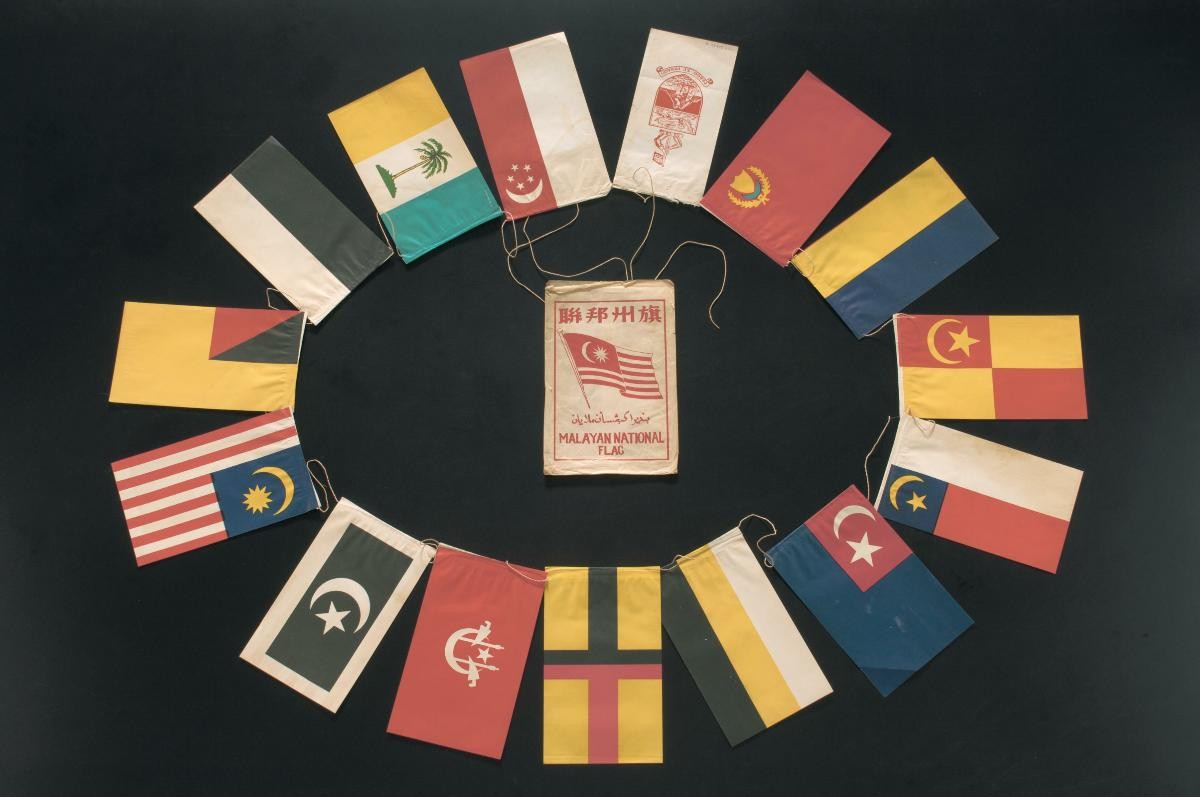 Paper flags of Malaysia, Malaysian states and Singapore strung together with a booklet in the centre