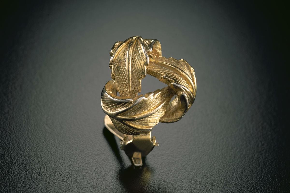 A pair of golden "leaf knot" ear studs that belonged to a notable women's rights activist