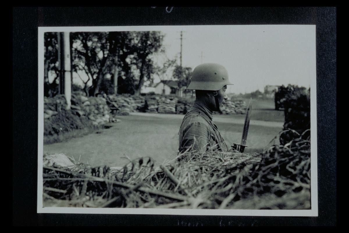 Japanese Occupation in Shanghai - A Chinese soldier stands guard with his bayonet
