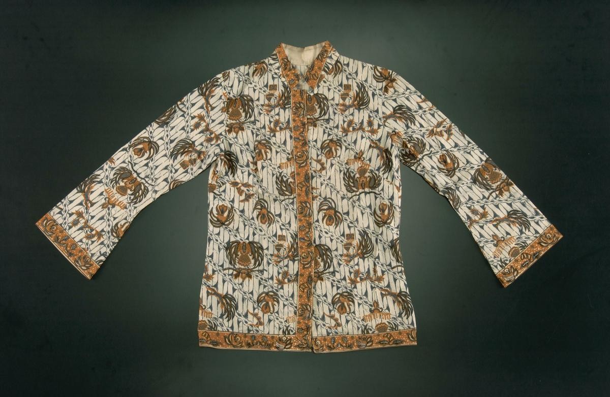 A white blouse with batik prints and long bell sleeves