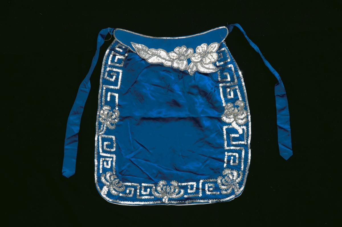 A blue waist piece with silver floral sequins worn by a ‘wu dan’ in a Chinese opera