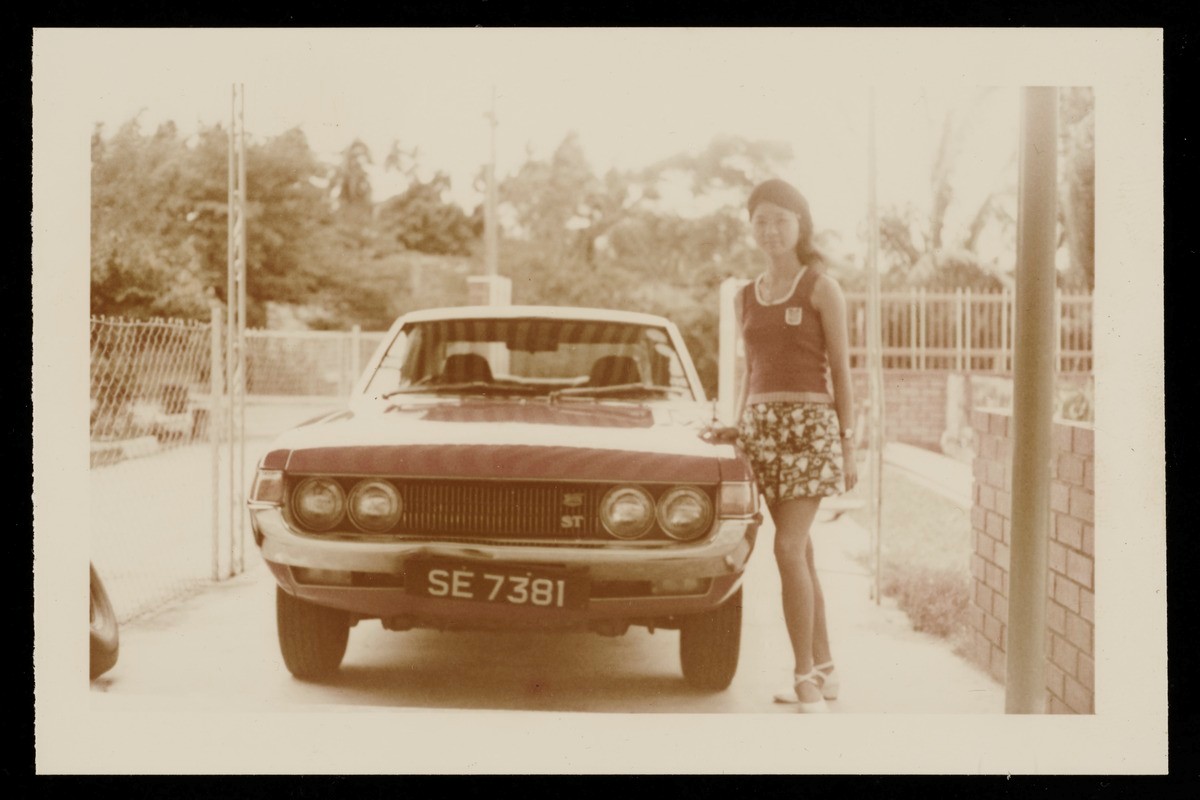 Photograph of Soh Beow Seng, Nancy, posing next to a Toyota Celica 1600ST car