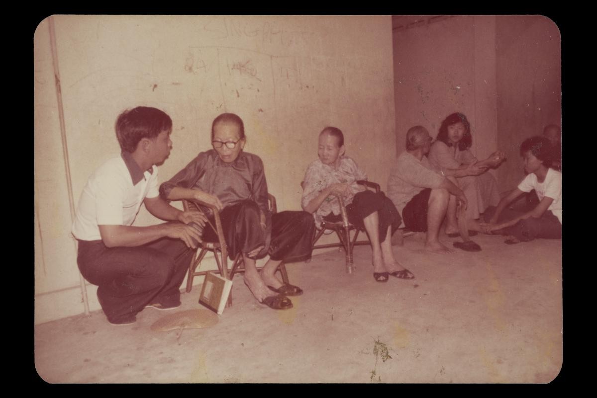 Photo of Bukit Merah Old Folks' Club members and volunteers socialising at corridor outside members' HDB rental flats