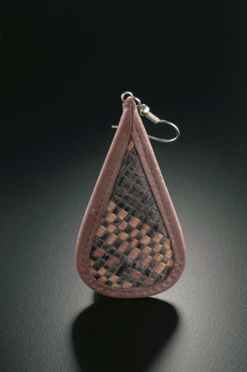 A pair of woven tear-drop shaped ear rings that belonged to a notable women's rights activist