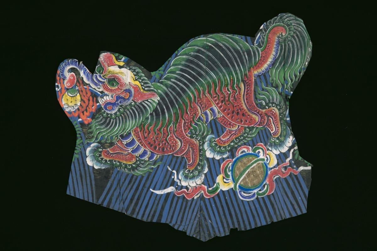A paper cut-out with a lion motif