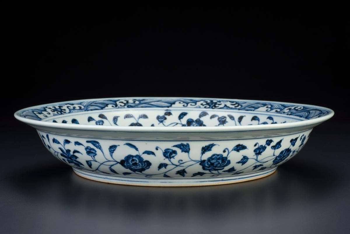 Large blue and white dish with floral scrolls