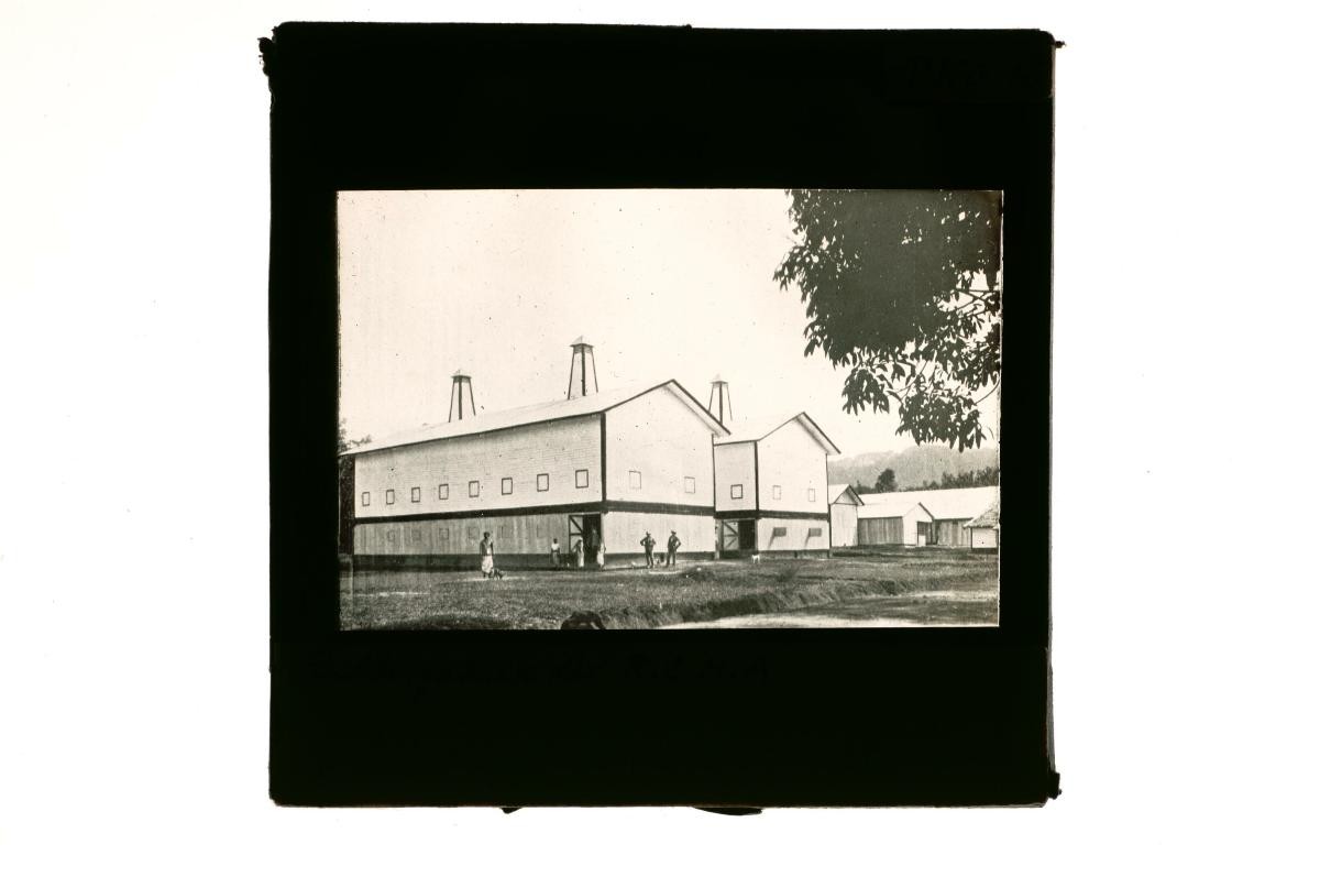 A glass lantern slide depicting a factory complex