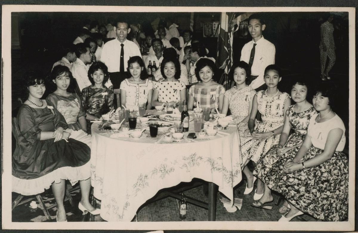 Women in Western frocks at dinner