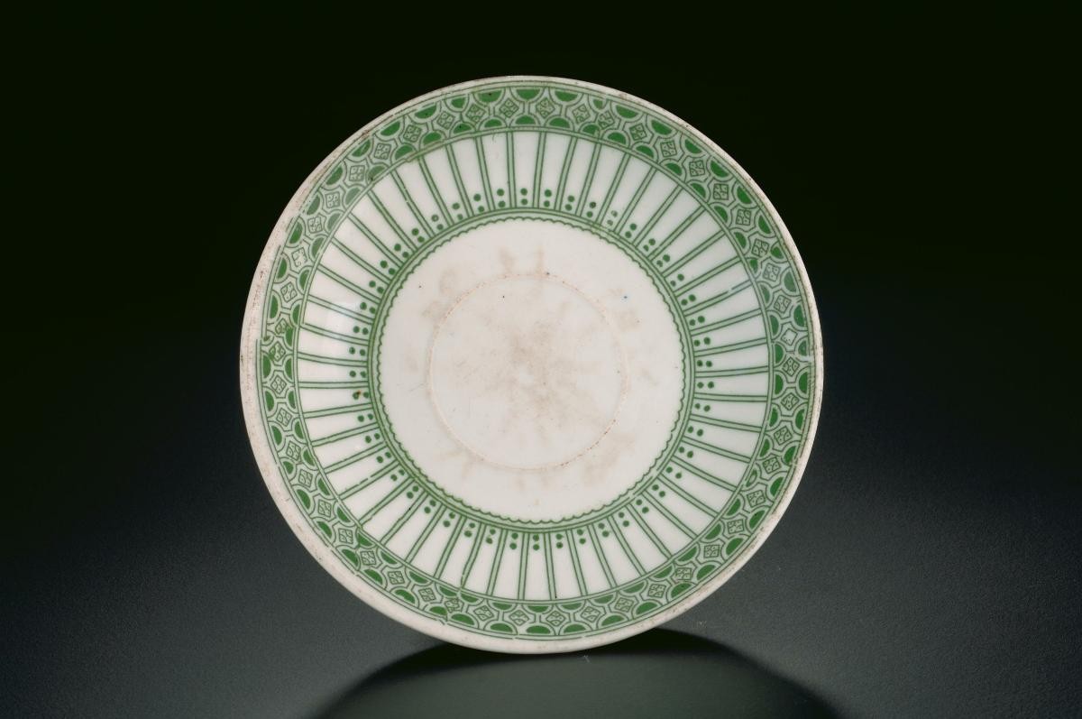 White porcelain saucer with green motif