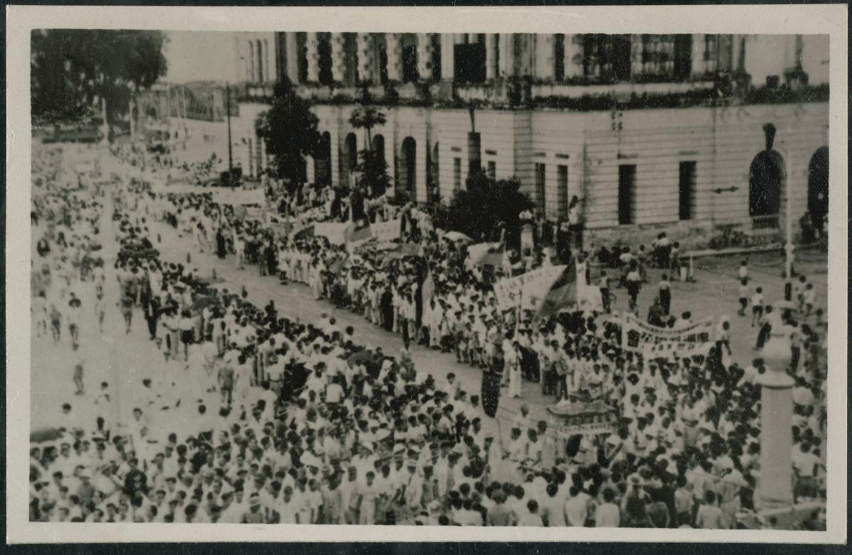 Civilians participating in a victory parade celebrating the Japanese surrender
