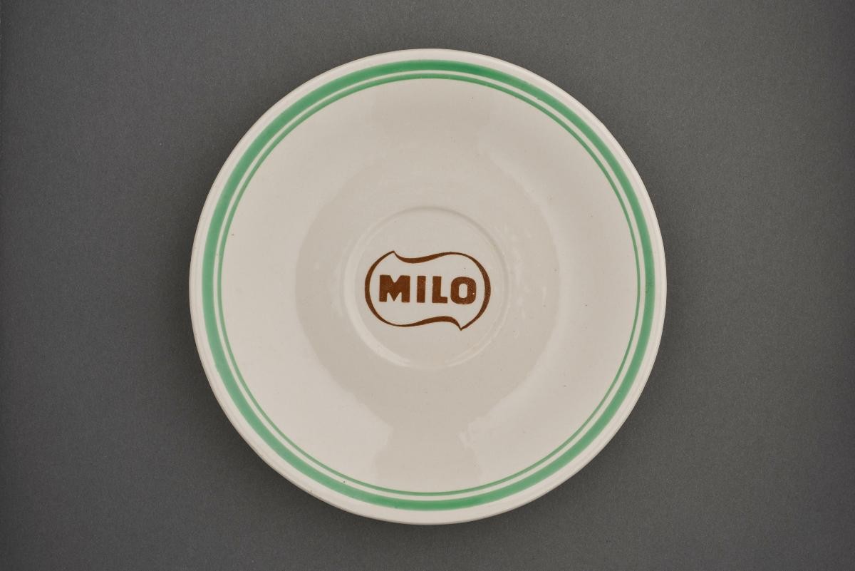 Porcelain saucer with green rim with ‘Milo’ logo