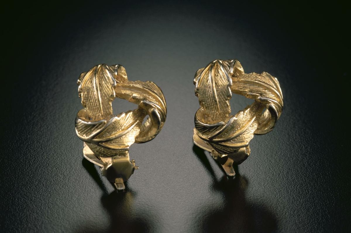 A pair of golden "leaf knot" ear studs that belonged to a notable women's rights activist