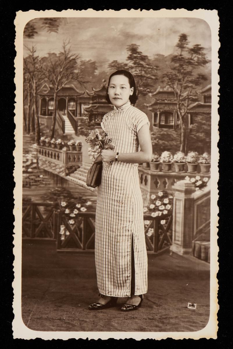 Studio portrait of a Chinese woman with a Chinese garden backdrop