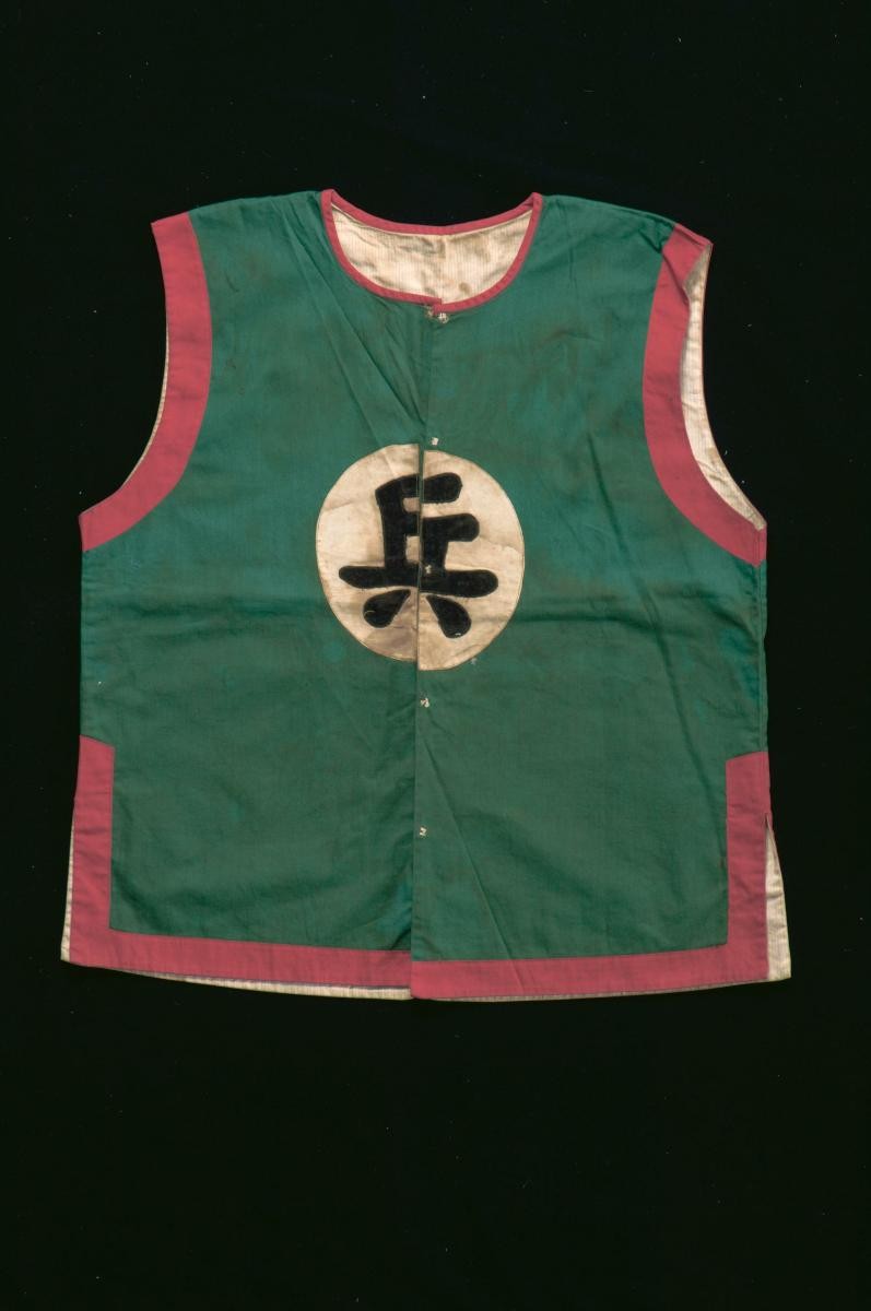 A sleeveless green and red vest worn by a soldier in a Chinese opera