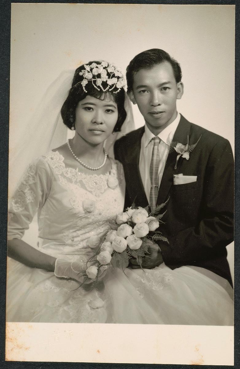 Studio portrait of a bride and groom wearing Western attire