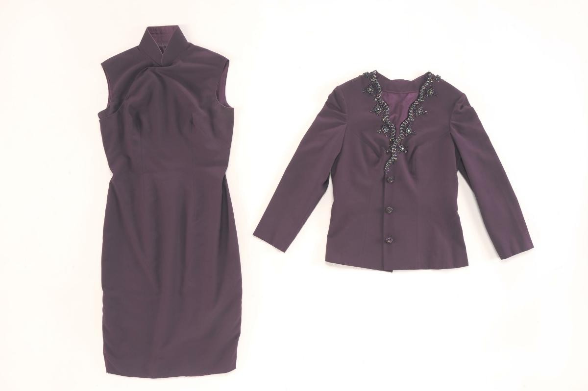 A purple cheongsam with a matching beaded jacket
