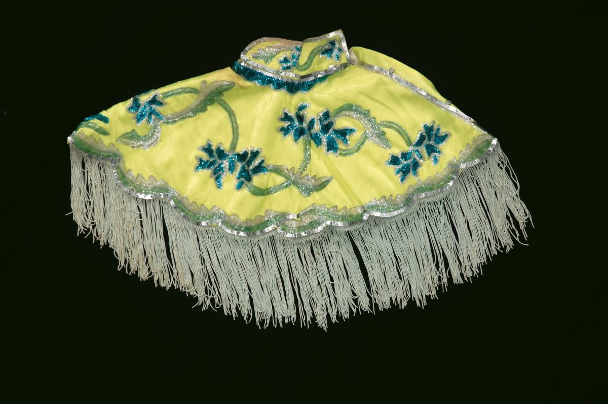A yellow shoulder piece with green floral sequins worn by a ‘wu dan’ in a Chinese opera