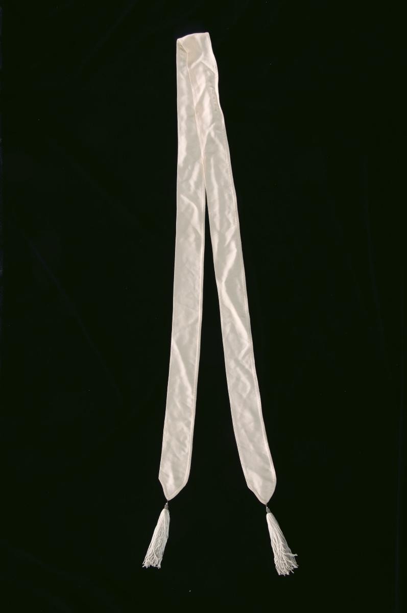 An ivory sash with tassels by Benny Ong