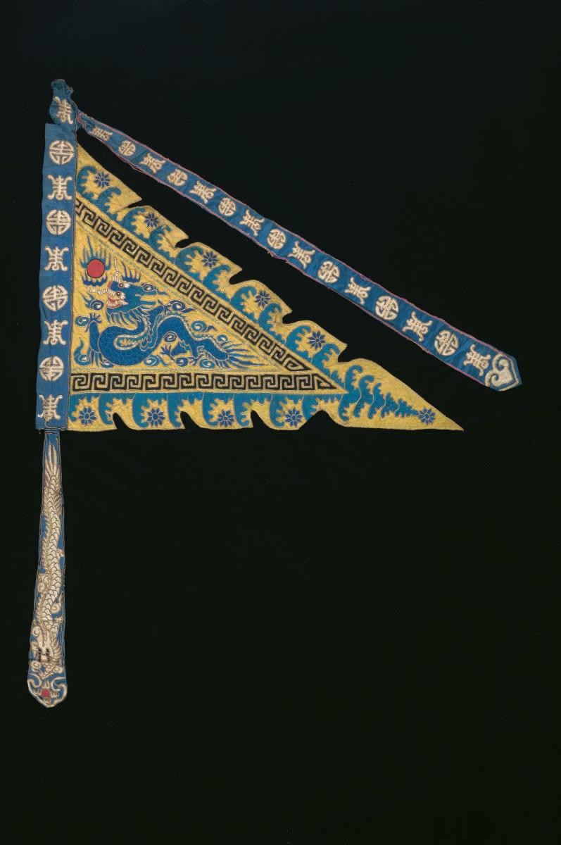 A yellow embroidered triangular pennant worn by a ‘wu sheng’ in a Chinese opera