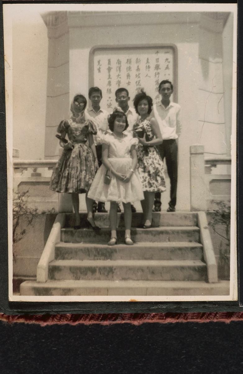 A group posing before a memorial
