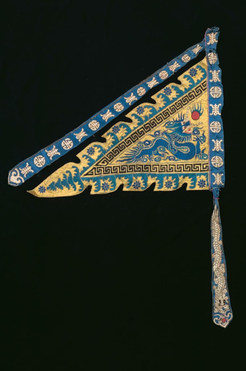 A yellow embroidered triangular pennant worn by a ‘wu sheng’ in a Chinese opera
