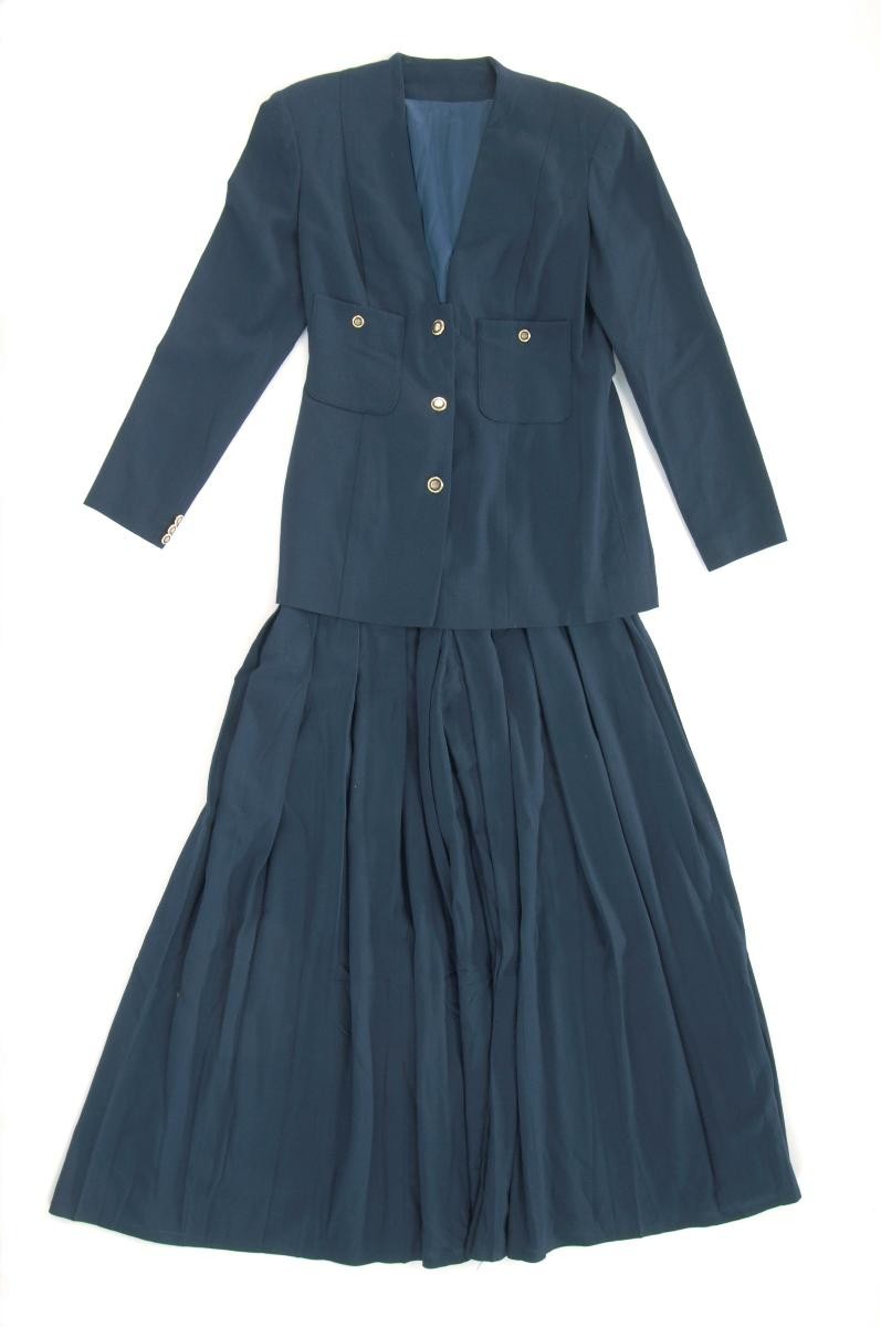 A navy blue suit of blazer and skirt by Andrew Gn