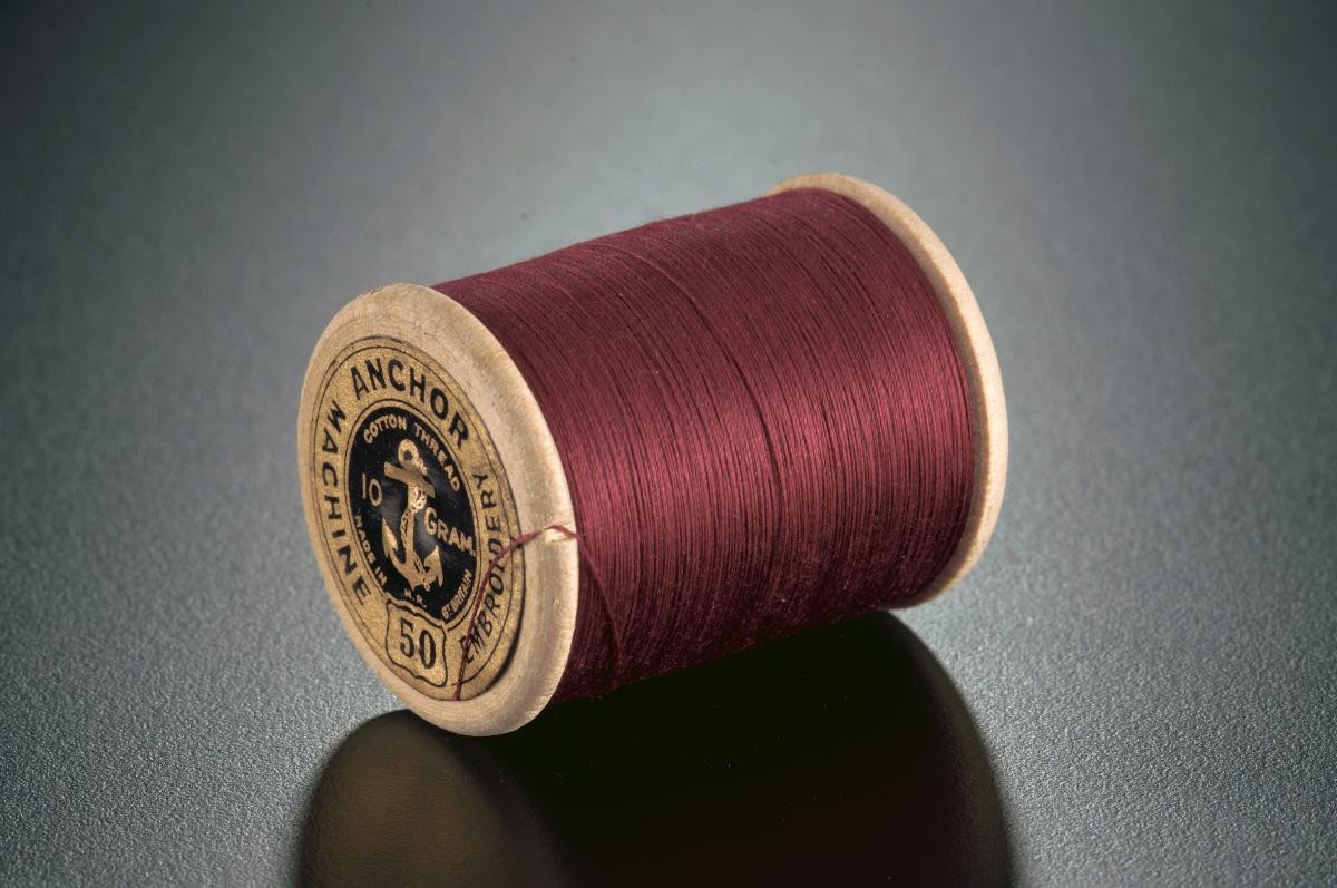 A spool of machine embroidery thread from Clark & Co’s Anchor Mills in Paisley