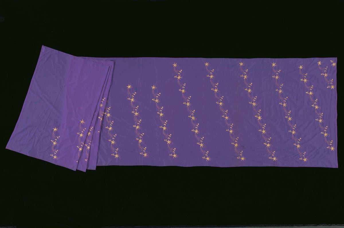 A purple sari with embroidered yellow and gold floral motifs