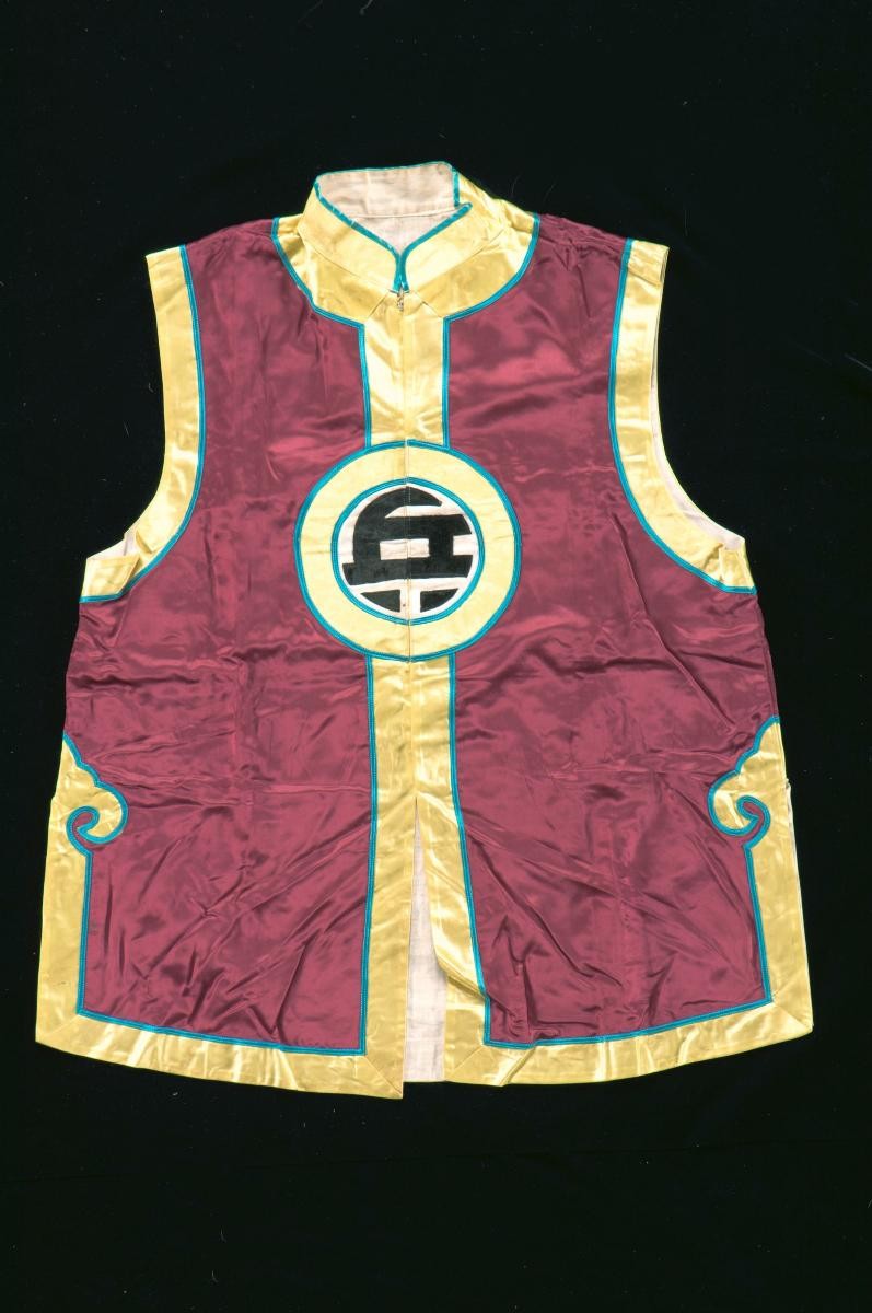 A sleeveless brown and yellow vest worn by a soldier in a Chinese opera