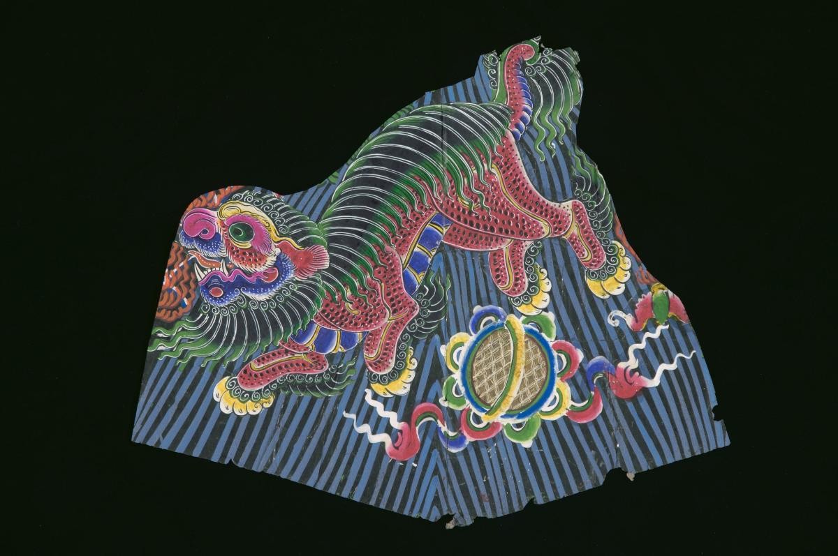 A paper cut-out with a lion motif