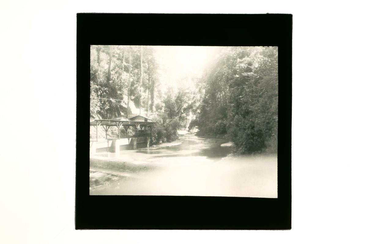 A glass lantern slide depicting a river scene