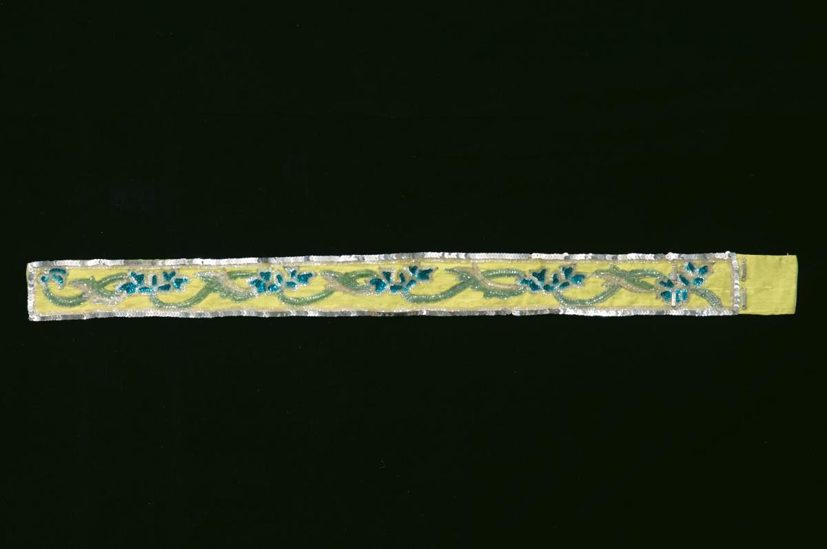 A yellow belt with green floral sequins worn by a ‘wu dan’ in a Chinese opera