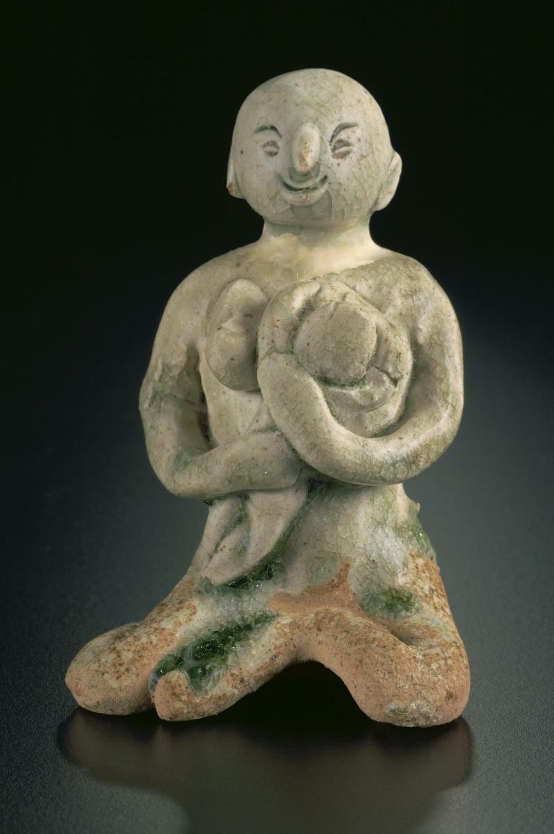 Miniature seated female figure with baby