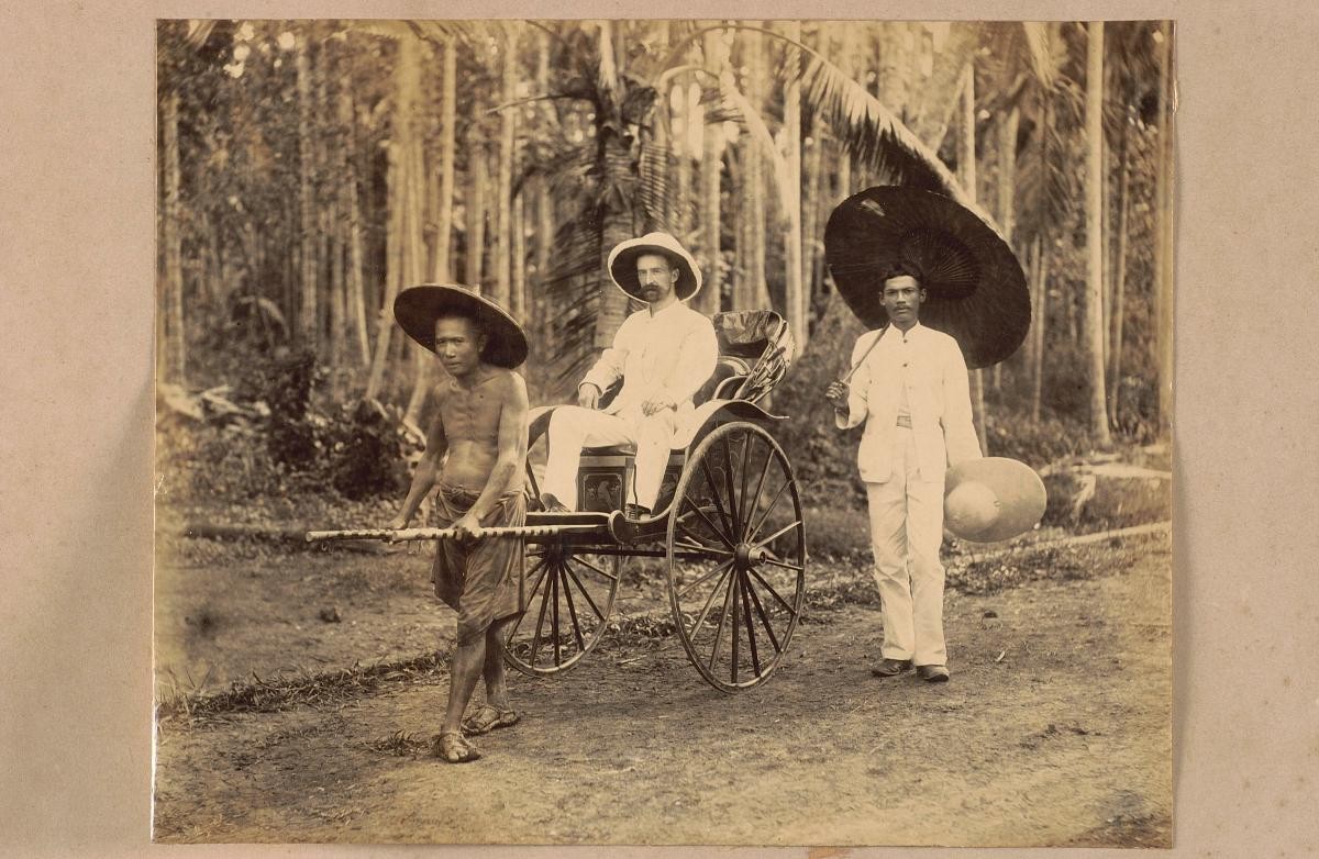 A rickshaw puller with a European passenger and attendant