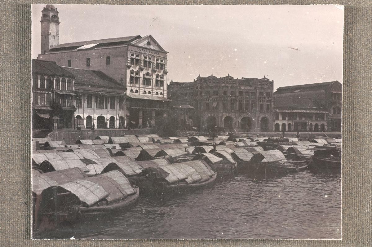 Shophouses and ‘twakow’ lighter vessels along the south bank of the Singapore River
